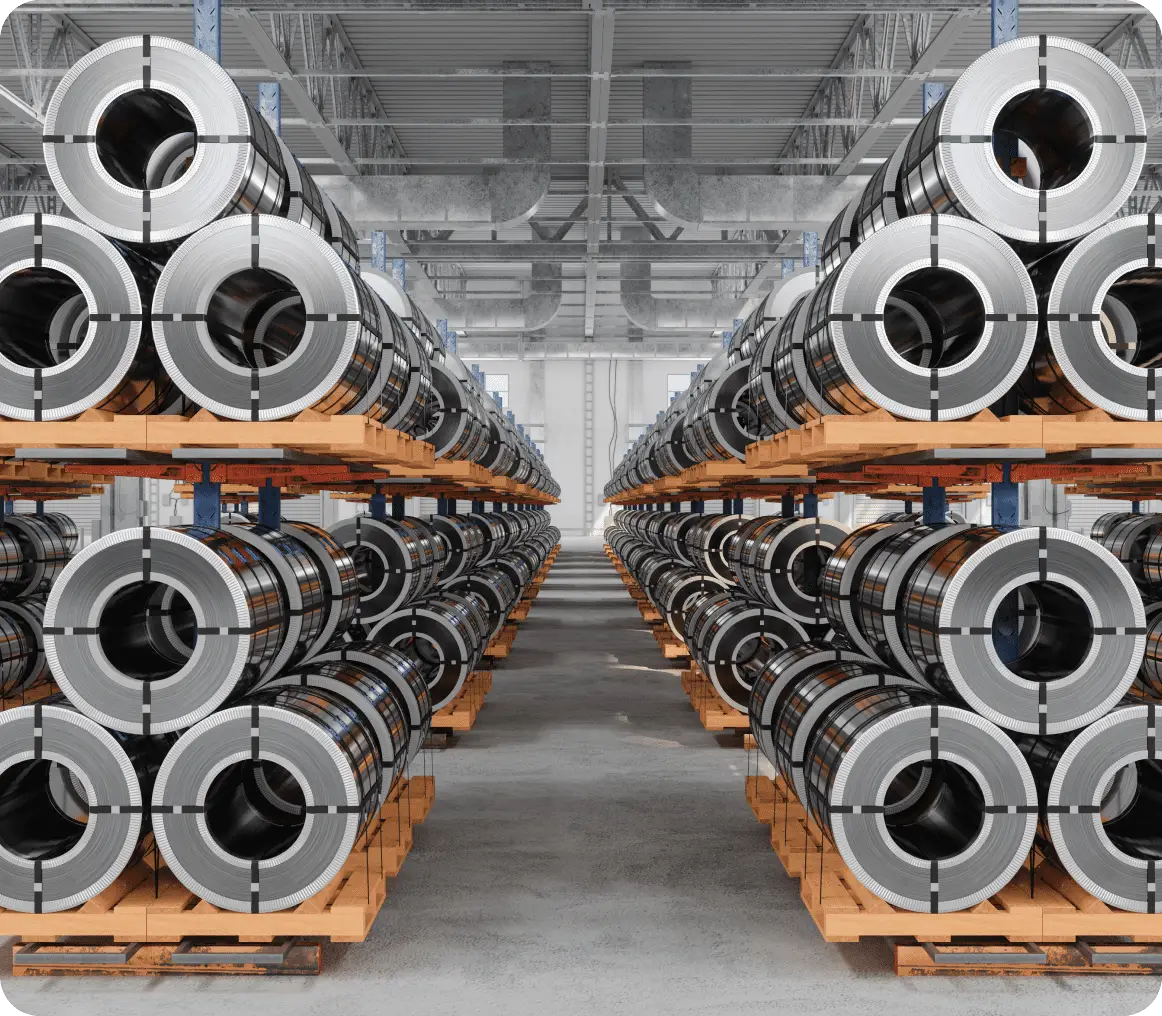 Metal coils stacked in a warehouse.